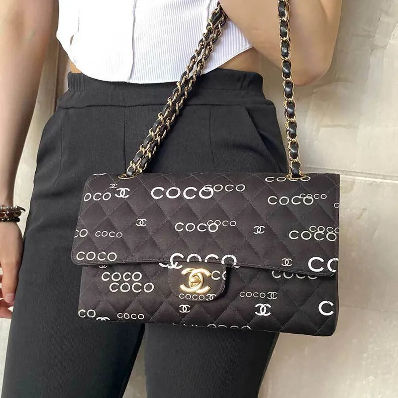 90173728-chanel-vintage-black-canvas-coco-print-flap-bag